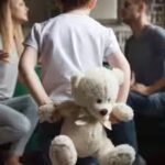 rear-view-at-kid-boy-holding-toy-while-parents-fighting.jpg