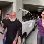 video-shows-andrew-tate-trying-to-hand-mobile-to-his-bodyguard.jpg