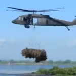 a-helicopter-dropping-its-first-bundle-of-trees-for-the-christmas-tree-drop-restoration-project-us-f.avif