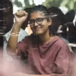 after-her-detention-neha-bora-posted-a-video-on-x-describing-the-police-bus-as-a-vehicle-with-four-c.avif