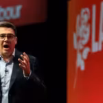 british-prime-minister-andy-burnham-reacts-on-stage-at-the-labour-partys-annual-conference-in-liverp.avif