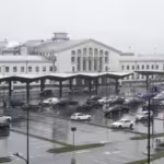 cars-wait-in-front-of-the-arrival-terminal-at-vilnius-ciurlionis-international-airport-in-vilnius.jp_.avif