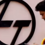 file-photo-an-employee-checks-his-phone-next-to-a-logo-of-lampt-outside-the-larsen-amp-toubro-precis.avif