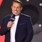 in-2014-tony-robbins-turned-a-childhood-memory-of-his-struggling-family-receiving-groceries-from-a-s.avif